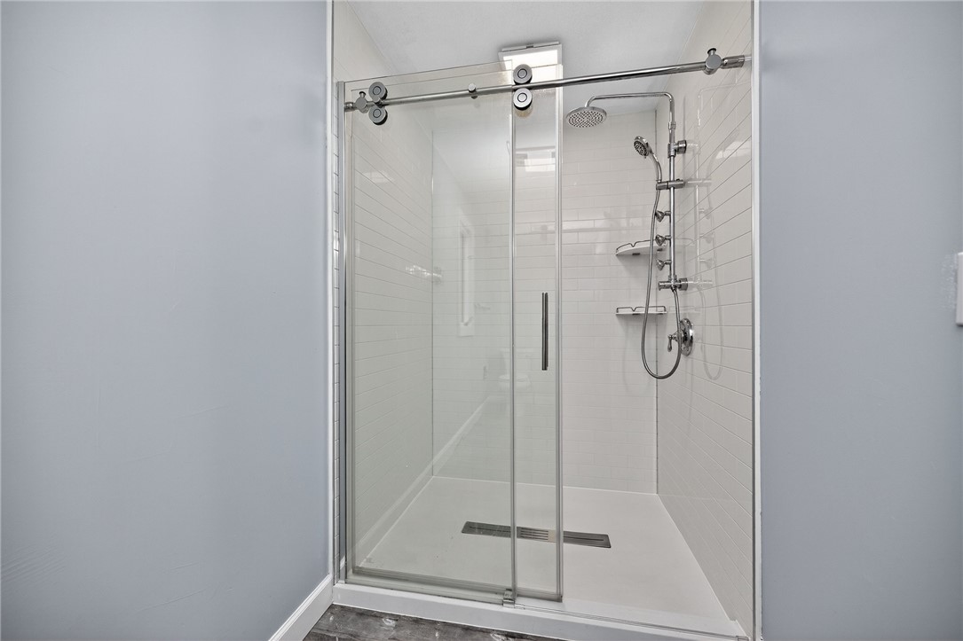 4747 Fawnwood Road Dayton, OH 45429 - Photo 31 of 58 This sleek shower features modern fixtures and bright tile, offering a refreshing bathing experience.