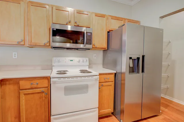 a view of storage and utility room with wooden floor