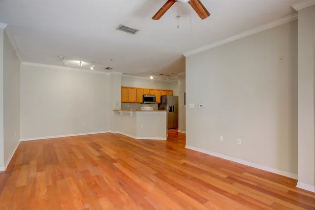 a view of a hallway with wooden floor and closet