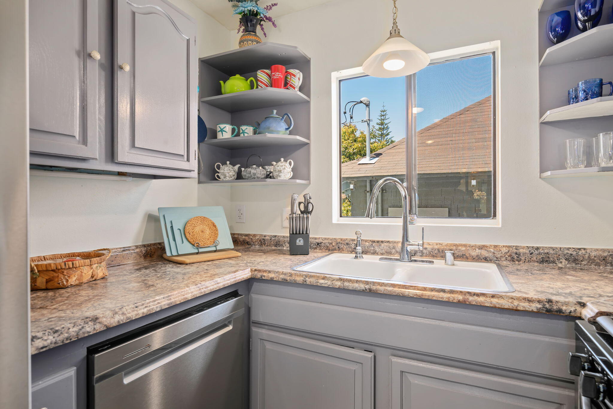 543 South E Street Oxnard, CA 93030 - Photo 11 of 30 a kitchen with granite countertop a sink and cabinets