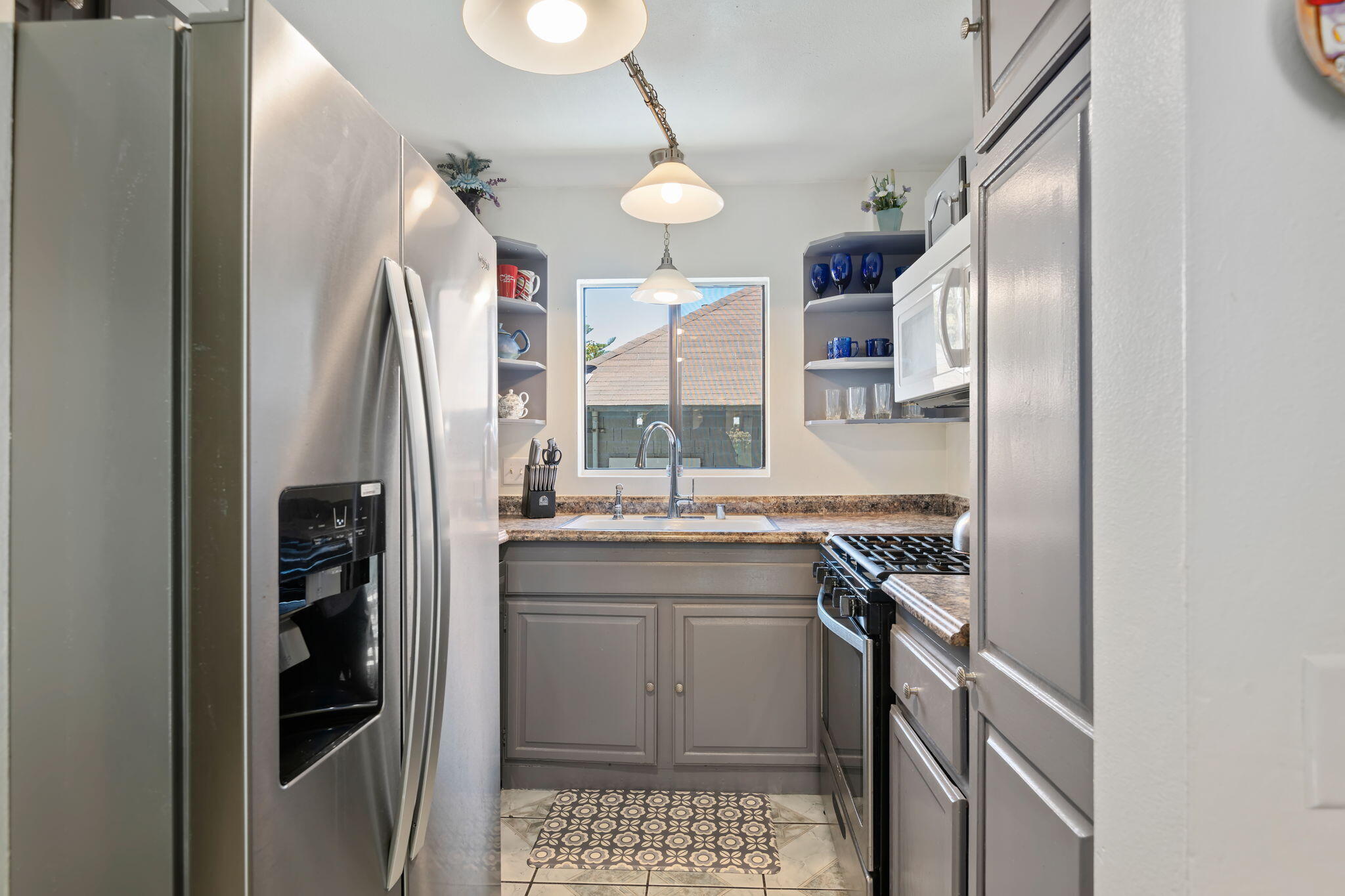543 South E Street Oxnard, CA 93030 - Photo 12 of 30 a kitchen with stainless steel appliances granite countertop a sink a stove a refrigerator and island