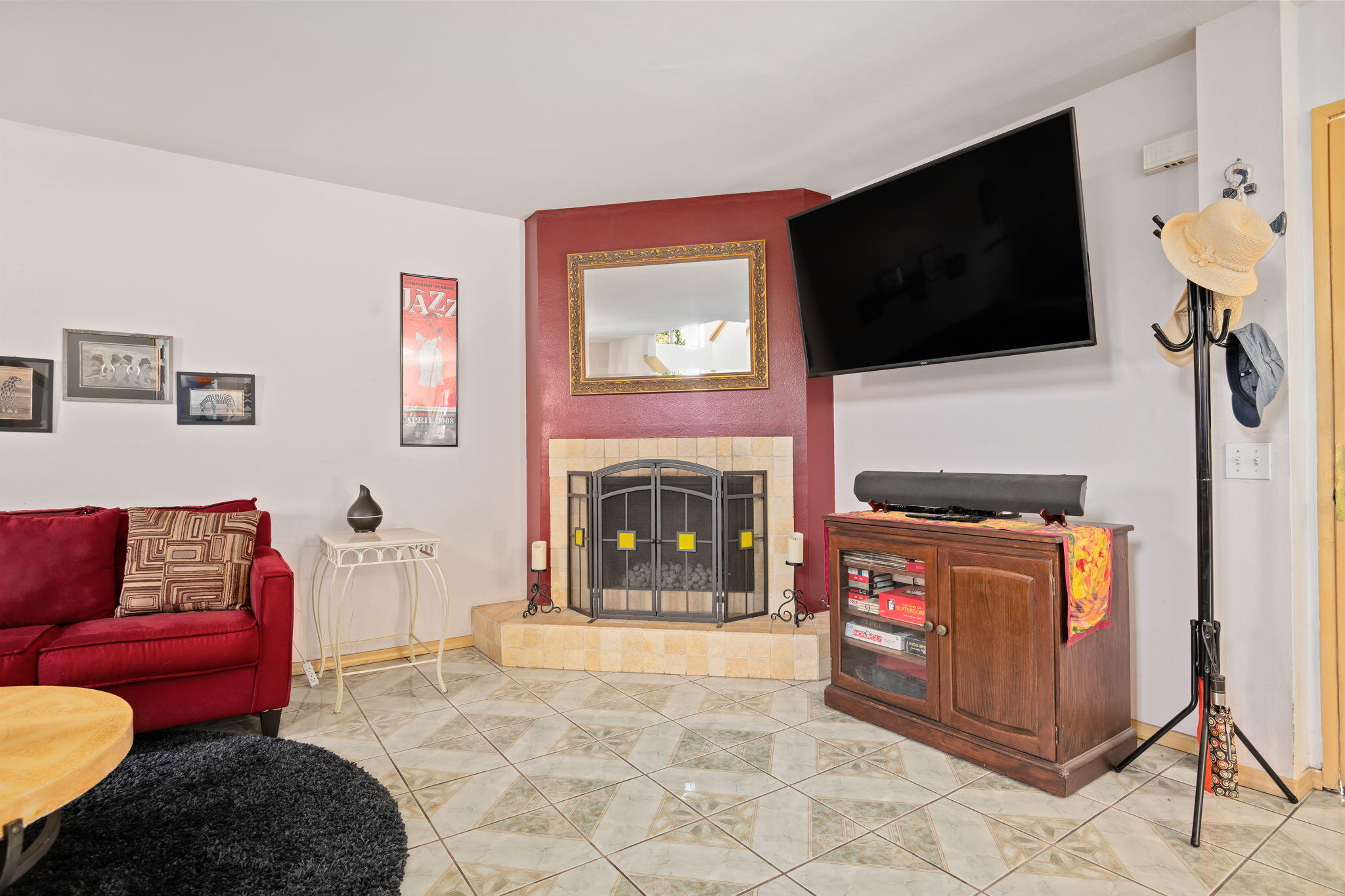 543 South E Street Oxnard, CA 93030 - Photo 5 of 30 a living room with furniture a flat screen tv and a fireplace