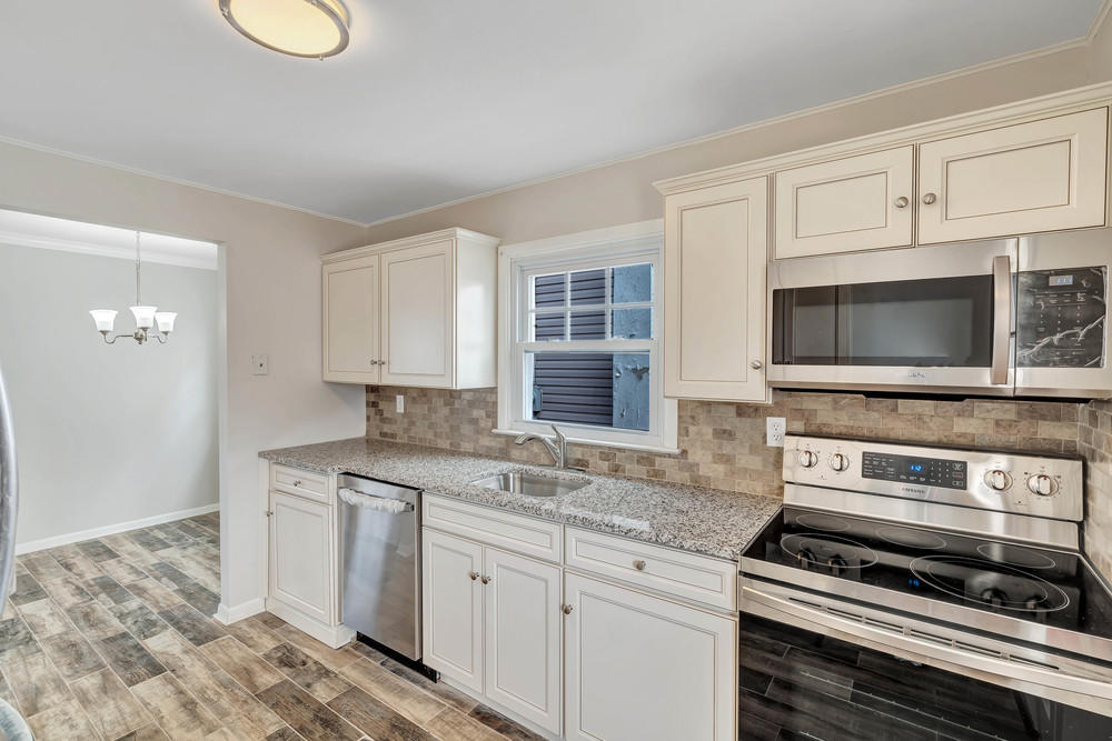 2210 Foster Road Point Pleasant, NJ 08742 - Photo 14 of 36 a kitchen with appliances a sink and cabinets