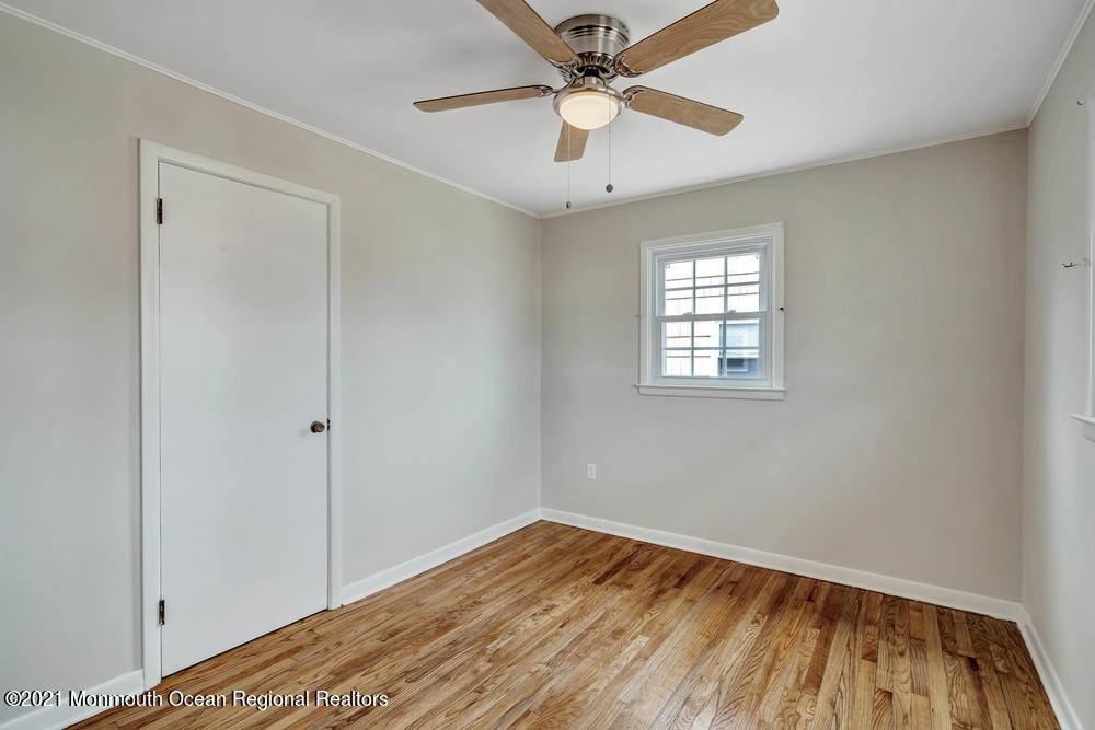 2210 Foster Road Point Pleasant, NJ 08742 - Photo 23 of 36 a view of empty room with wooden floor and fan