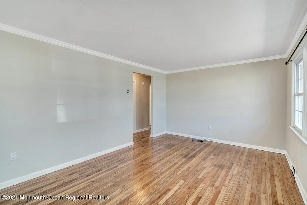 2210 Foster Road Point Pleasant, NJ 08742 - Photo 7 of 36 a view of an empty room with wooden floor and a window