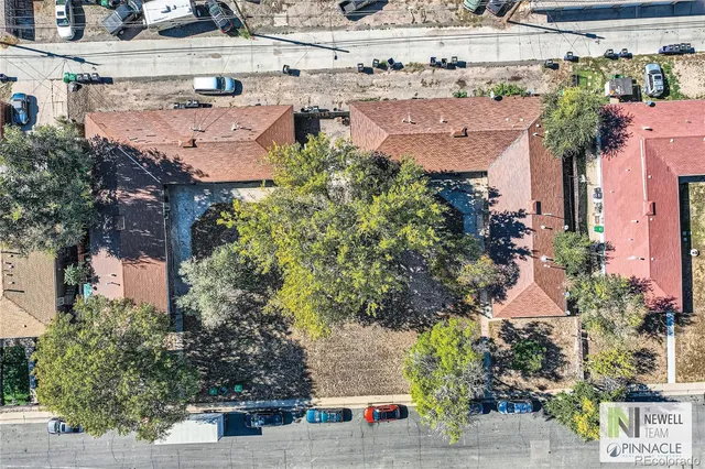an aerial view of multiple houses with yard