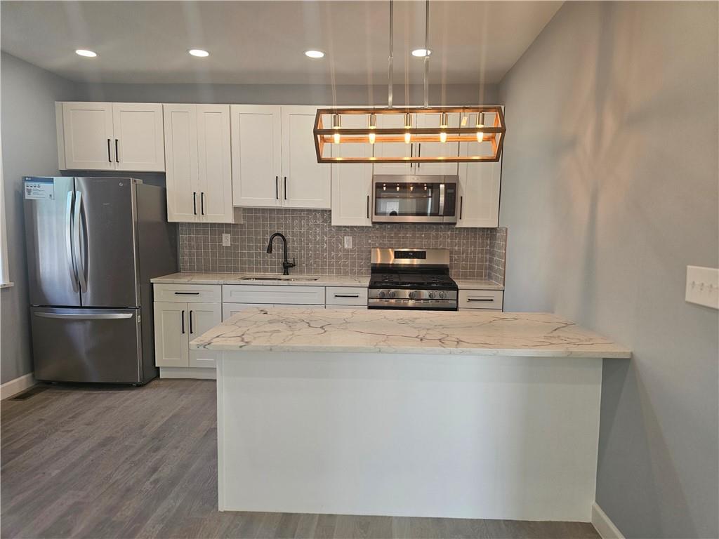 531 Reno Street Rochester, PA 15074 - Photo 5 of 11 a kitchen with stainless steel appliances granite countertop a sink a stove and a refrigerator