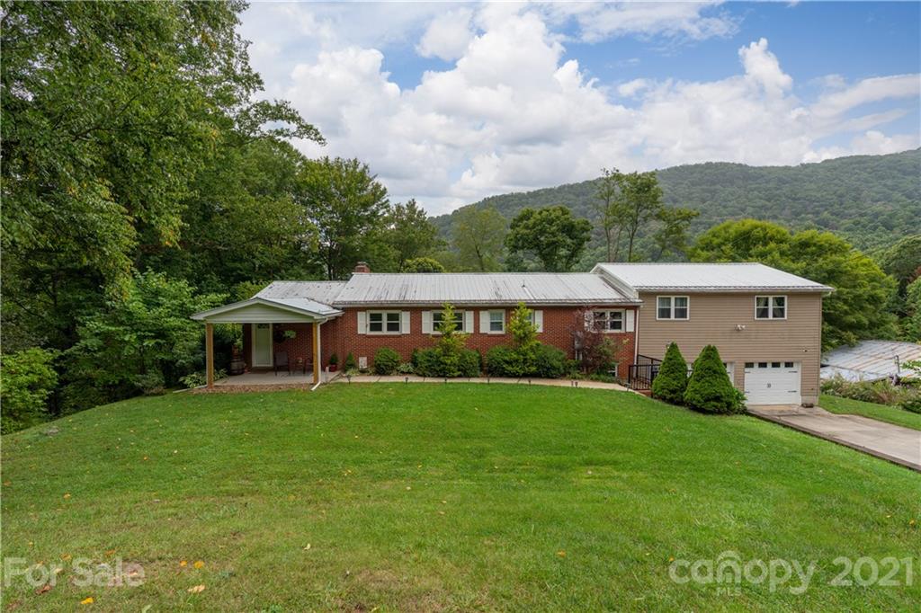 188 Stewart Road Waynesville, NC 28786 - Photo 45 of 45 a view of a big house with a big yard and large trees