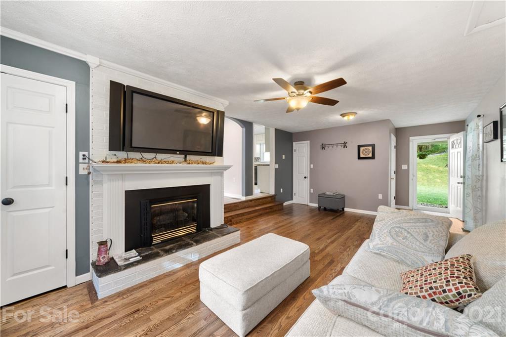 188 Stewart Road Waynesville, NC 28786 - Photo 8 of 45 a living room with furniture fireplace and flat screen tv