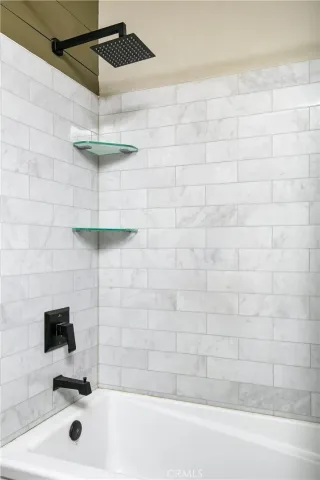 a bathroom with a sink a mirror and shower