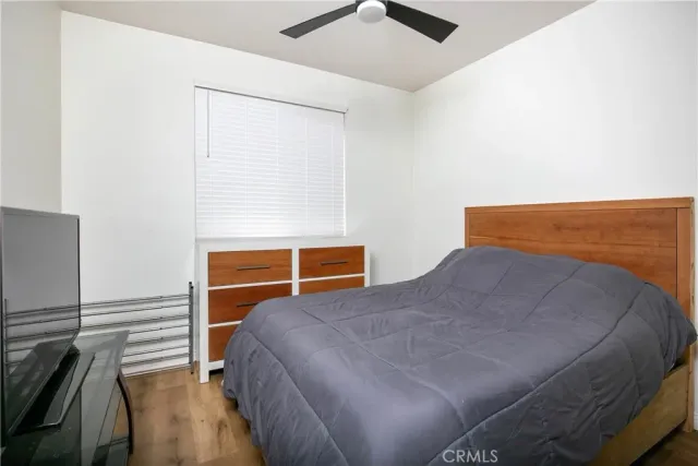 a bedroom with a bed and ceiling fan