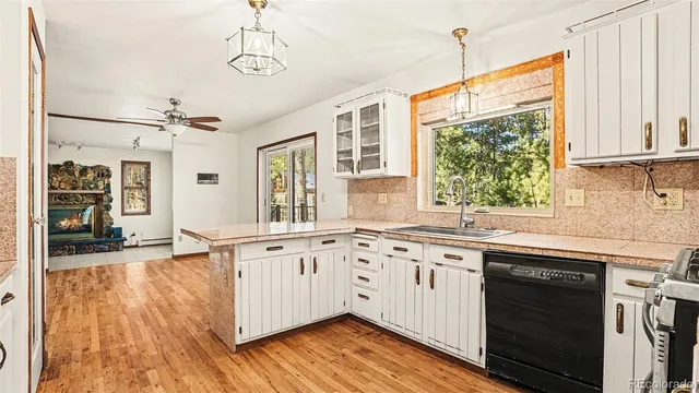 a kitchen with granite countertop white cabinets and white appliances