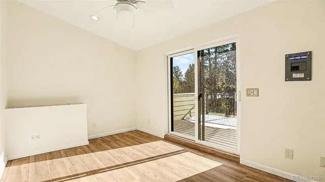 a view of a room with wooden floor