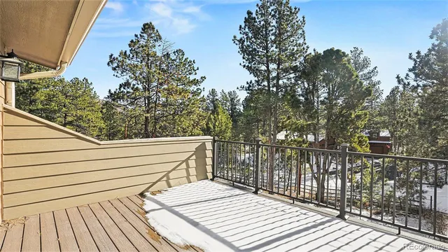 a view of balcony with wooden floor and fence