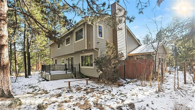 a wooden bench sitting in front of a house