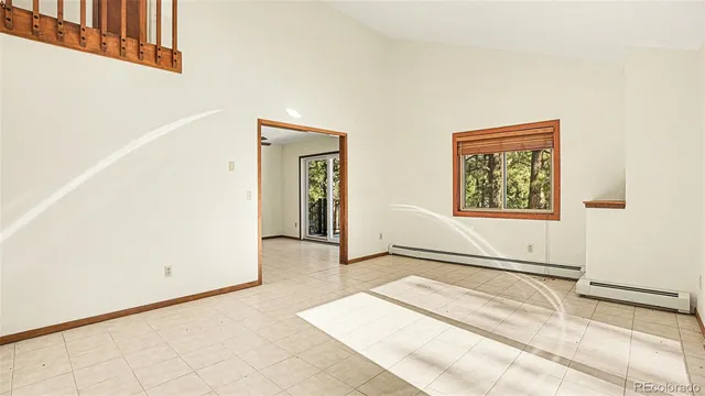 a view of a livingroom with wooden floor and a large window
