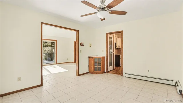 an empty room with closet and a chandelier fan