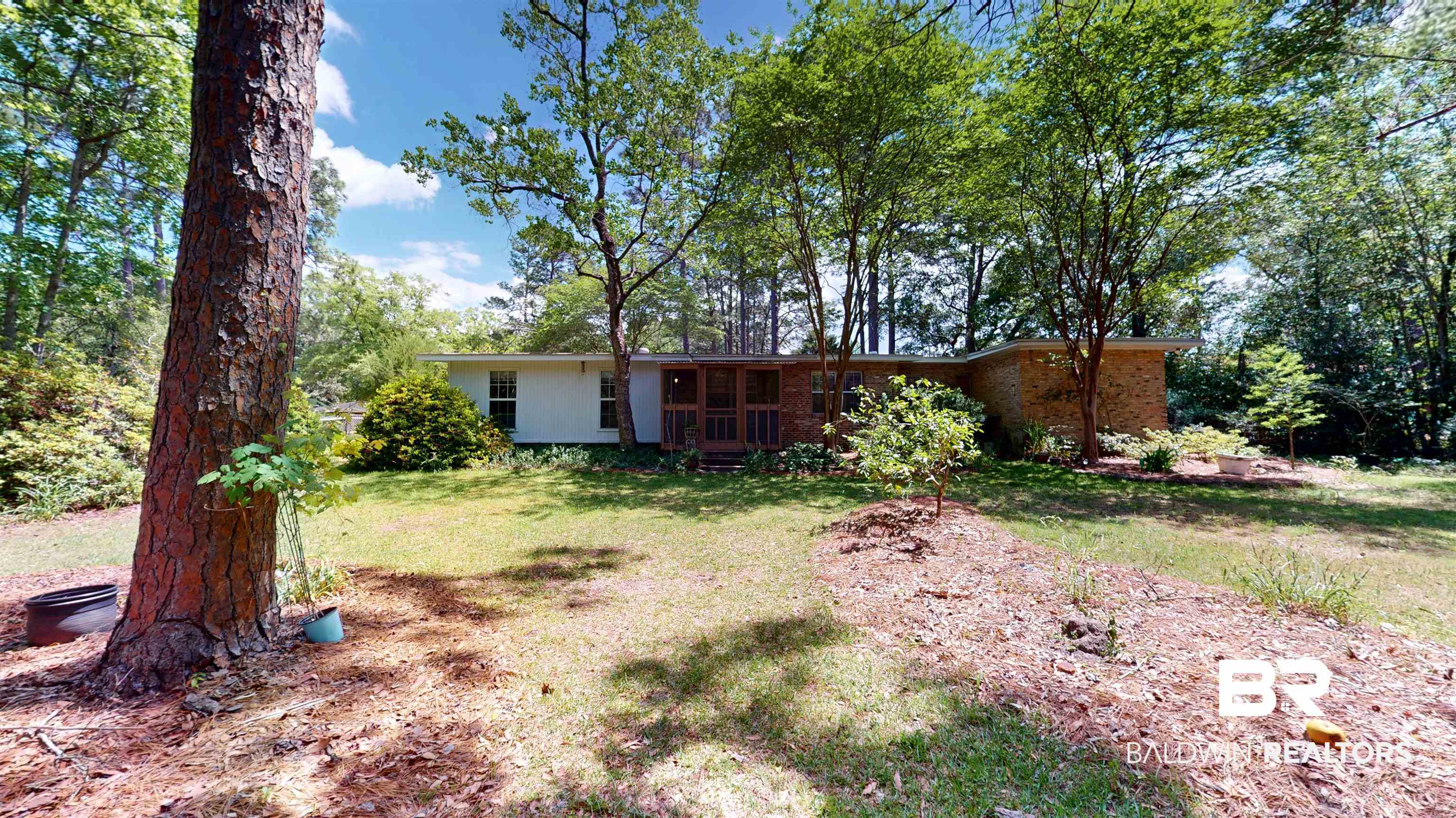 1075 Zurich Street Mobile, AL 36608 - Photo 7 of 35 Rear view of property featuring a yard, brick siding, and view of scattered trees