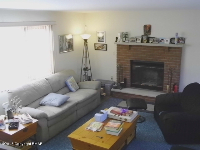 7229 Clover Road Long Pond, PA 18334 - Photo 3 of 22 a living room with furniture and a fireplace