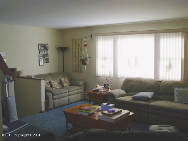 7229 Clover Road Long Pond, PA 18334 - Photo 4 of 22 a living room with furniture couches and a large window