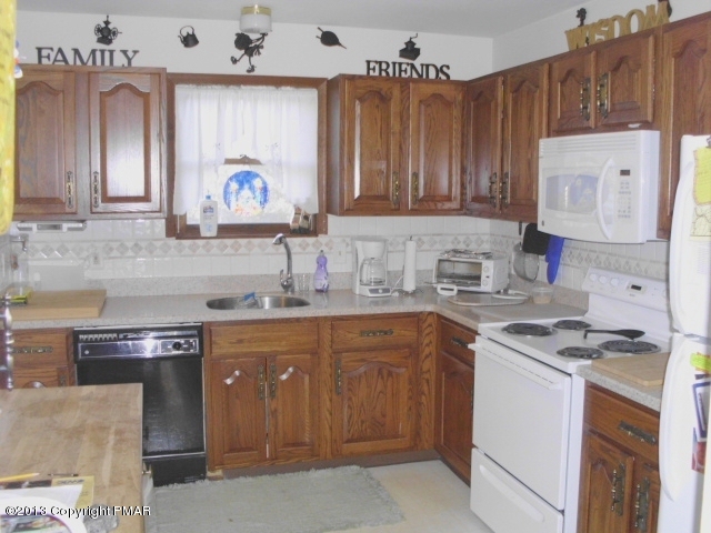 7229 Clover Road Long Pond, PA 18334 - Photo 5 of 22 a kitchen with stainless steel appliances granite countertop a sink stove and cabinets