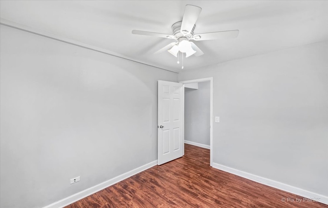 1050 North Wheeling Road, Unit 2A Mount Prospect, IL 60056 - Photo 13 of 13 an empty room with wooden floor and fan