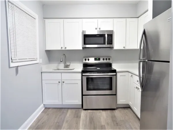 a kitchen with stainless steel appliances a refrigerator stove and microwave