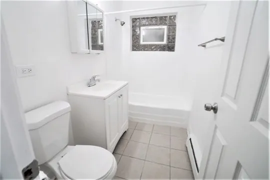 a white toilet sitting next to a bathroom sink