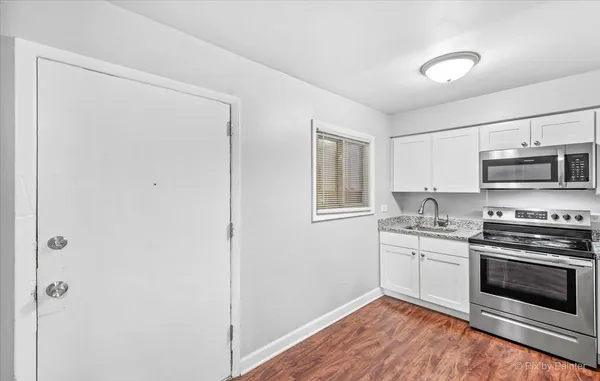 a kitchen with stainless steel appliances a stove a microwave and cabinets