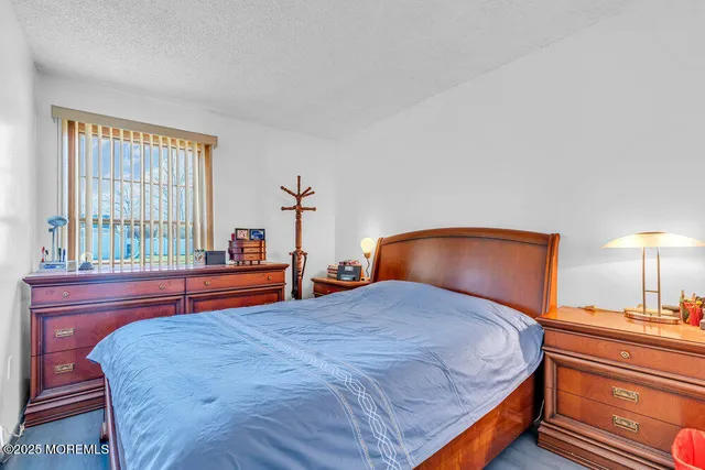 a bedroom with a bed and a large mirror