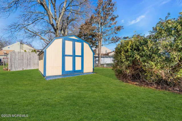a view of a big yard with plants and large trees