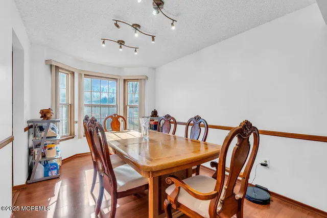a view of a dining room with furniture and a window