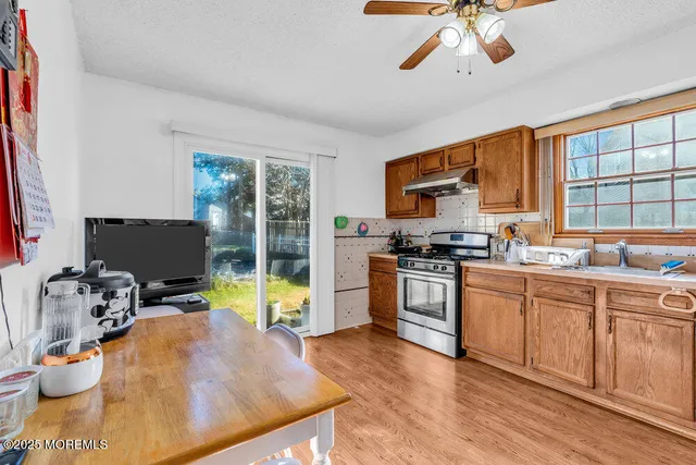 a kitchen with a sink appliances and cabinets