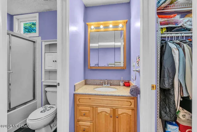 a bathroom with a sink a toilet and a shower