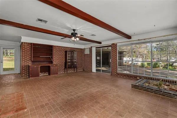 a view of a livingroom with an empty space and a fireplace