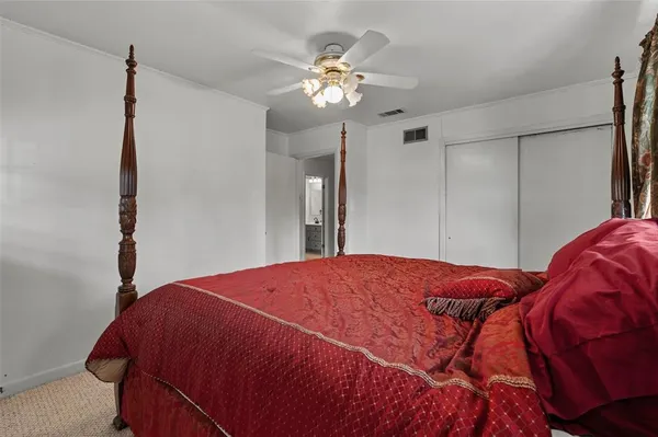 a bedroom with a large bed and a chandelier