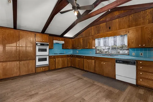 a kitchen with stainless steel appliances wooden cabinets a stove and a refrigerator