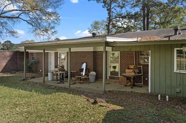 a view of a house with backyard porch and sitting area