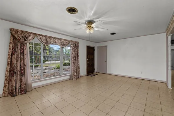 an empty room with windows and outdoor view