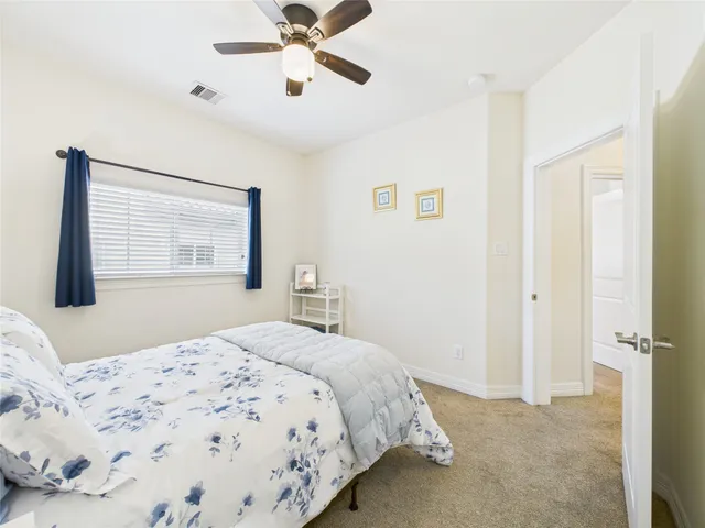 a bedroom with a bed and painting on the wall