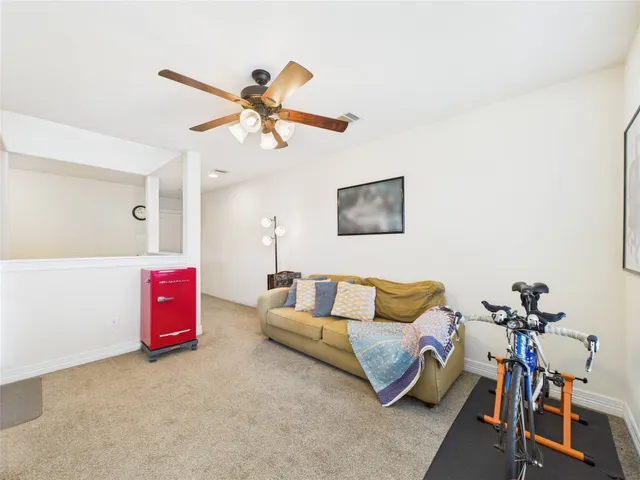 a front view of a house with a yard and potted plants