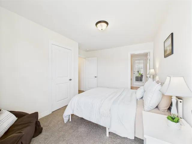 a front view of a house with a yard and potted plants