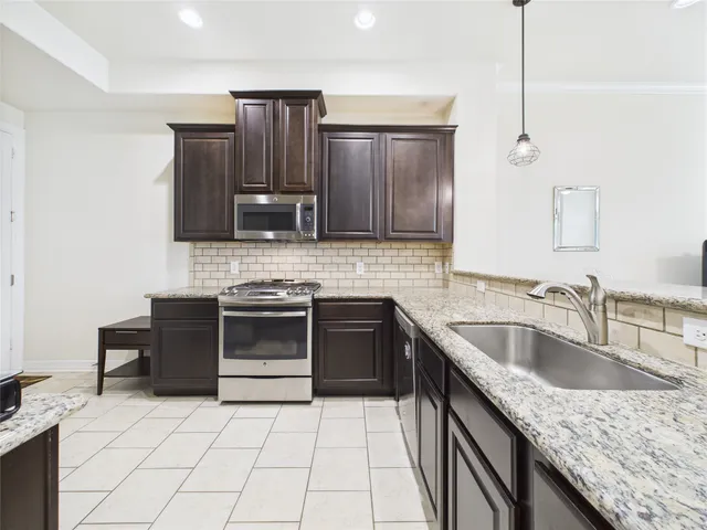a kitchen with stainless steel appliances a refrigerator and a stove