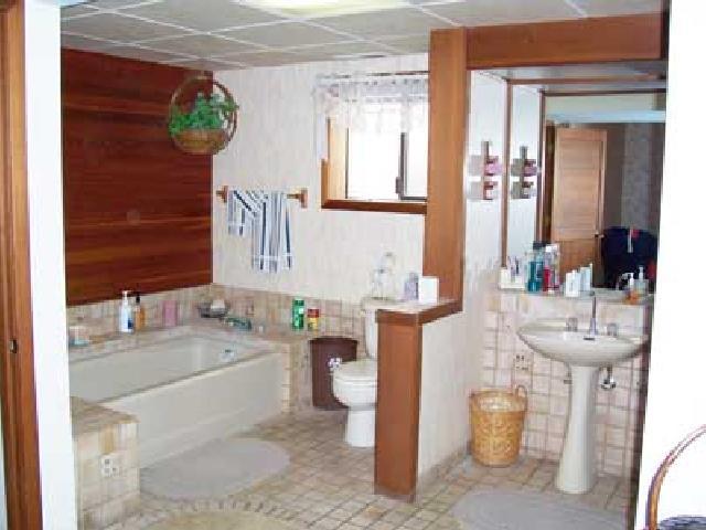 9450 Bittner Road Yakima, WA 98901 - Photo 7 of 9 a bathroom with a sink a toilet and a mirror