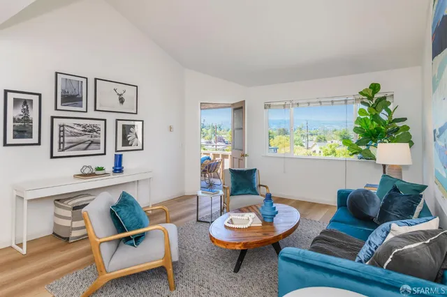 a living room with furniture and a potted plant