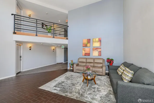 a view of a patio with dining table and chairs with plants and wooden fence