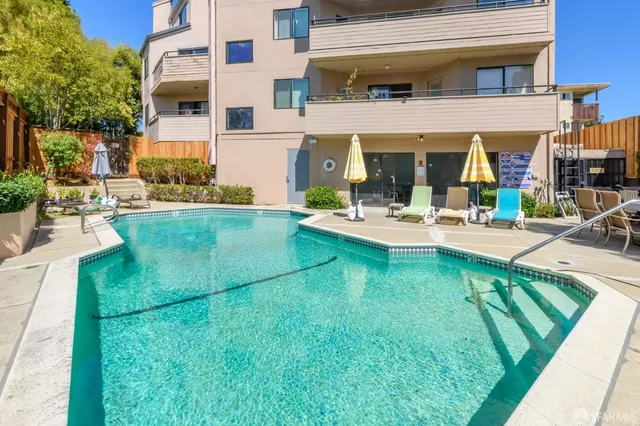 a view of a chairs and table in the back yard of the house
