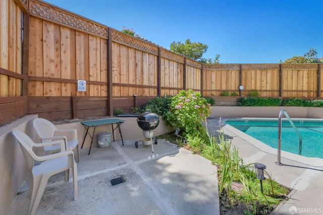 a view of a patio with table and chairs and potted plants