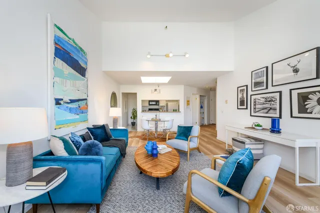 a living room with furniture and kitchen view