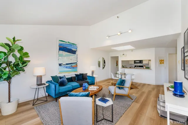a living room with furniture a window and a wooden floor